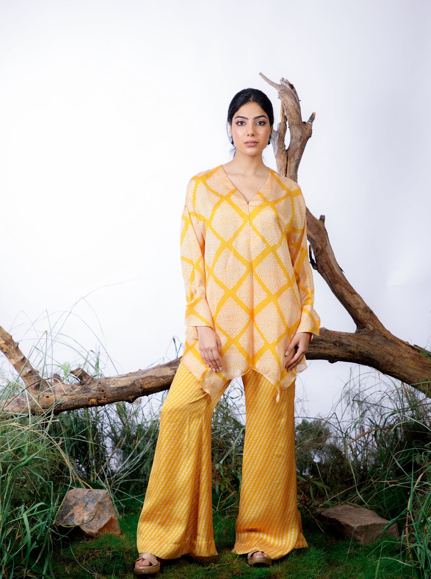 Contrasting Bandhani prints with an oversized asymmetrical cut top paired with a bootleg trouser