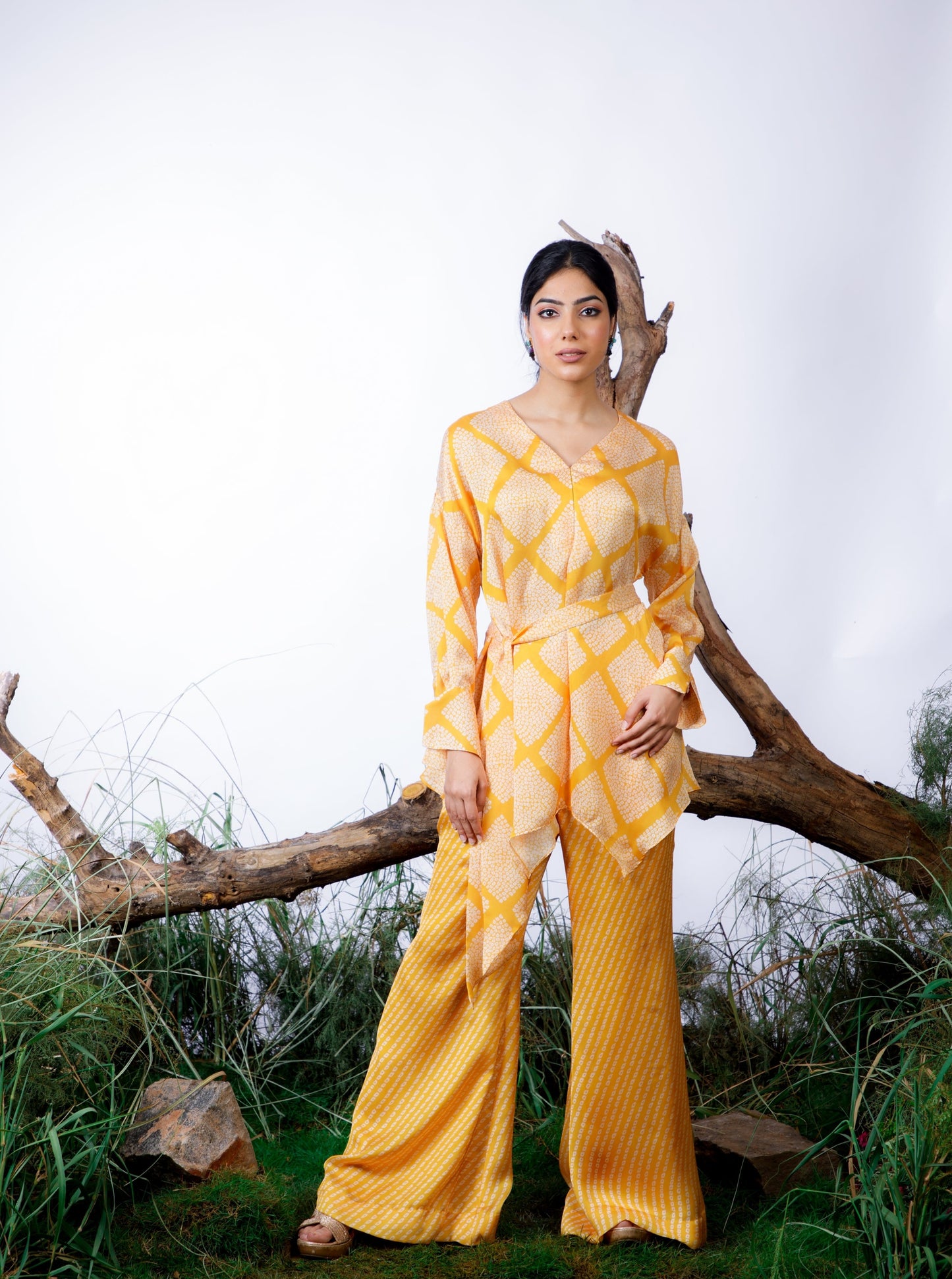 Contrasting Bandhani prints with an oversized asymmetrical cut top paired with a bootleg trouser