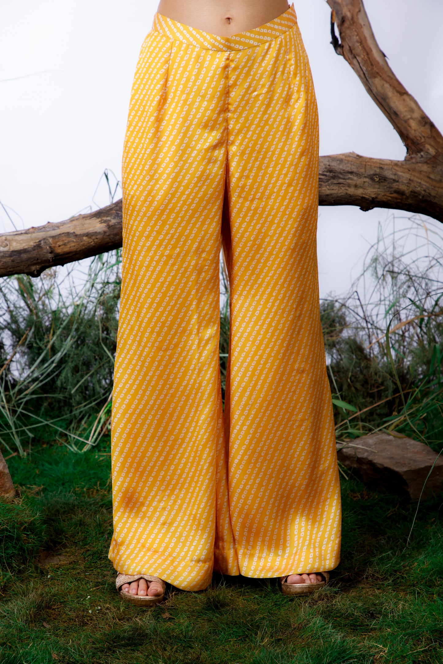 Contrasting Bandhani prints with an oversized asymmetrical cut top paired with a bootleg trouser