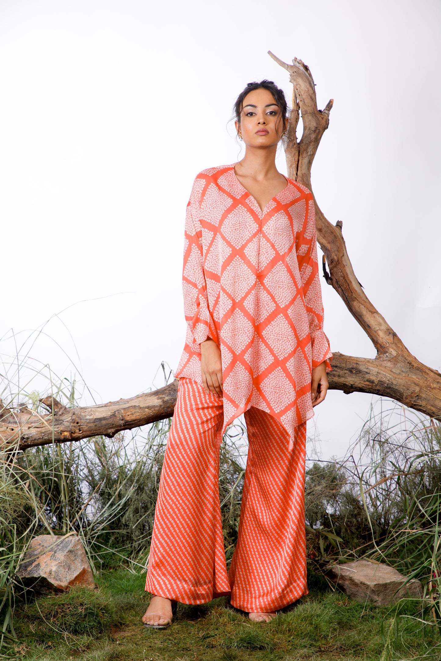 Contrasting Bandhani prints with an oversized asymmetrical cut top paired with a bootleg trouser