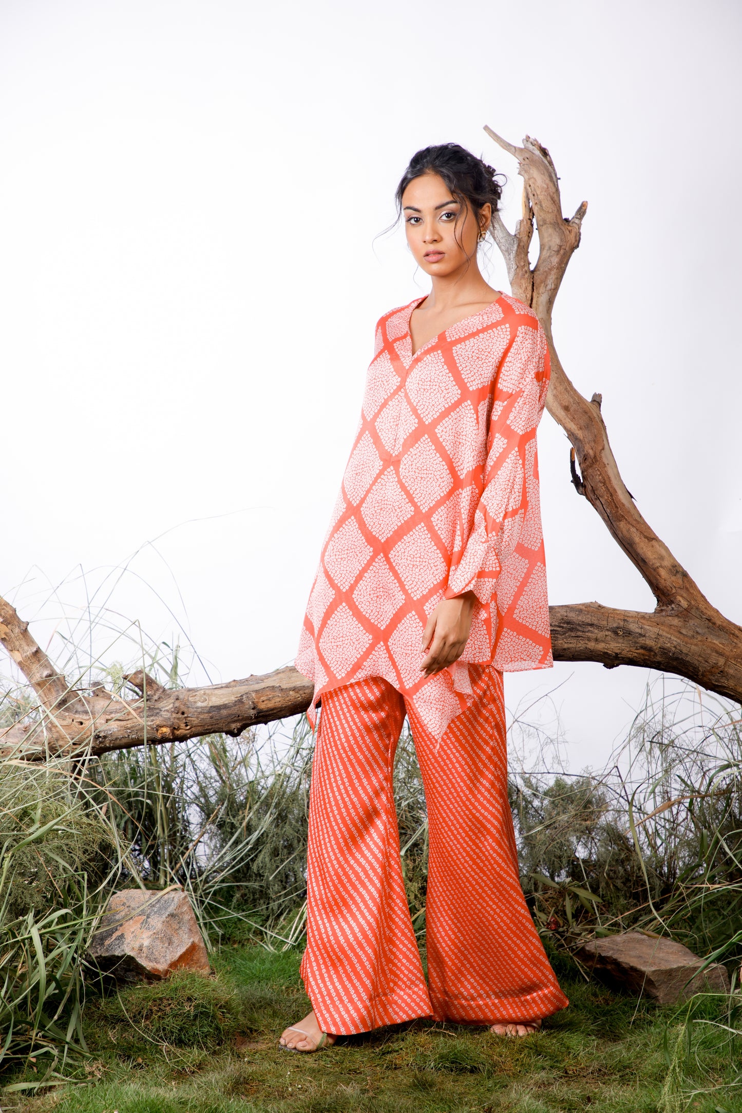 Contrasting Bandhani prints with an oversized asymmetrical cut top paired with a bootleg trouser