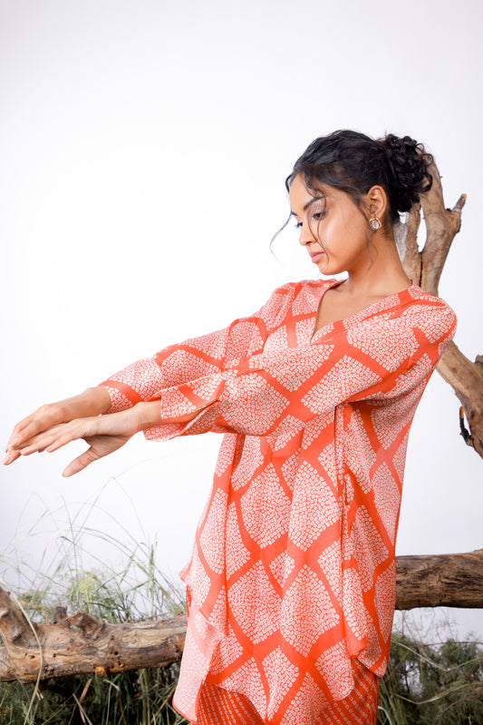 Contrasting Bandhani prints with an oversized asymmetrical cut top paired with a bootleg trouser