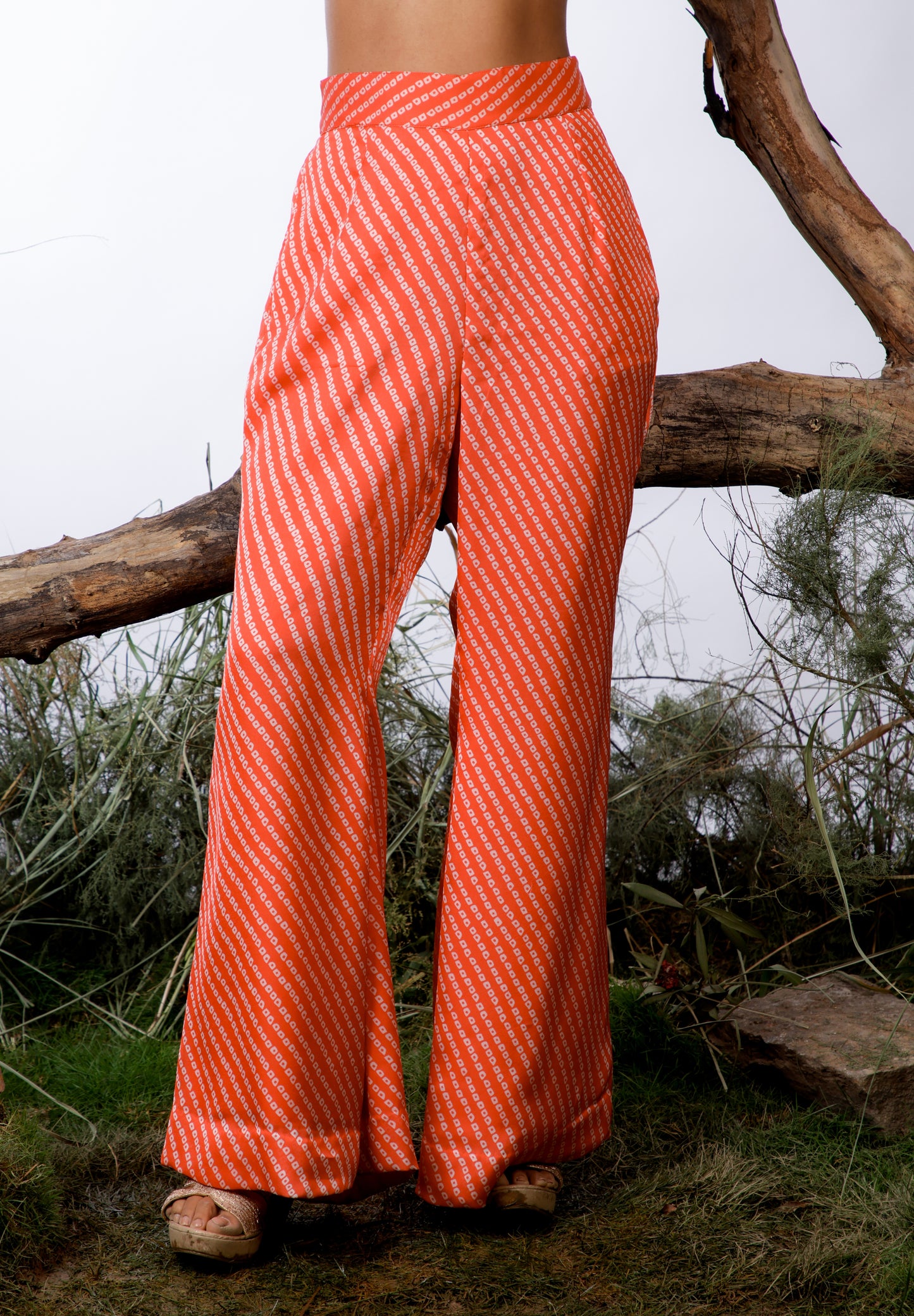 Contrasting Bandhani prints with an oversized asymmetrical cut top paired with a bootleg trouser