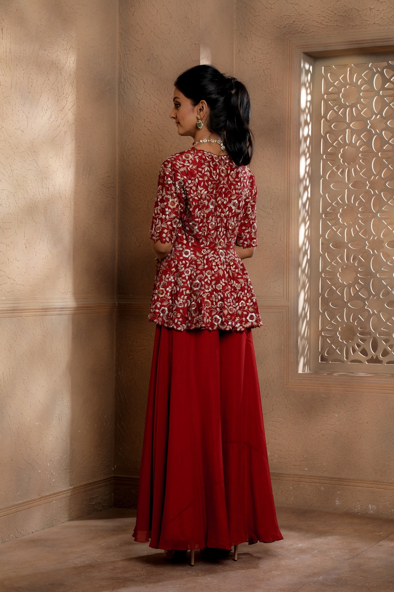 Red Floral Embroidered peplum with contrasting embroidery in hues of gold with an Organza Sharara.