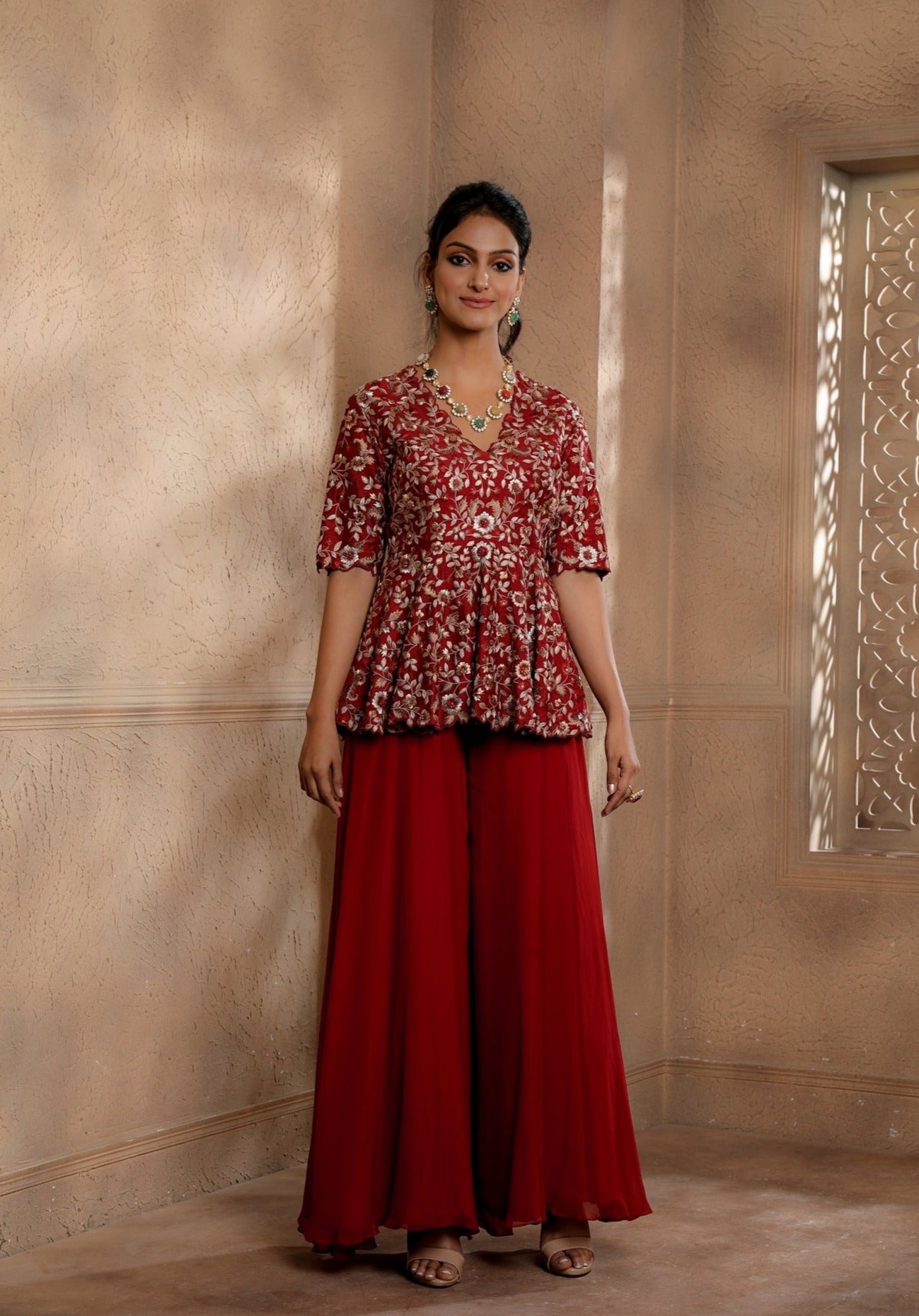 Red Floral Embroidered peplum with contrasting embroidery in hues of gold with an Organza Sharara.