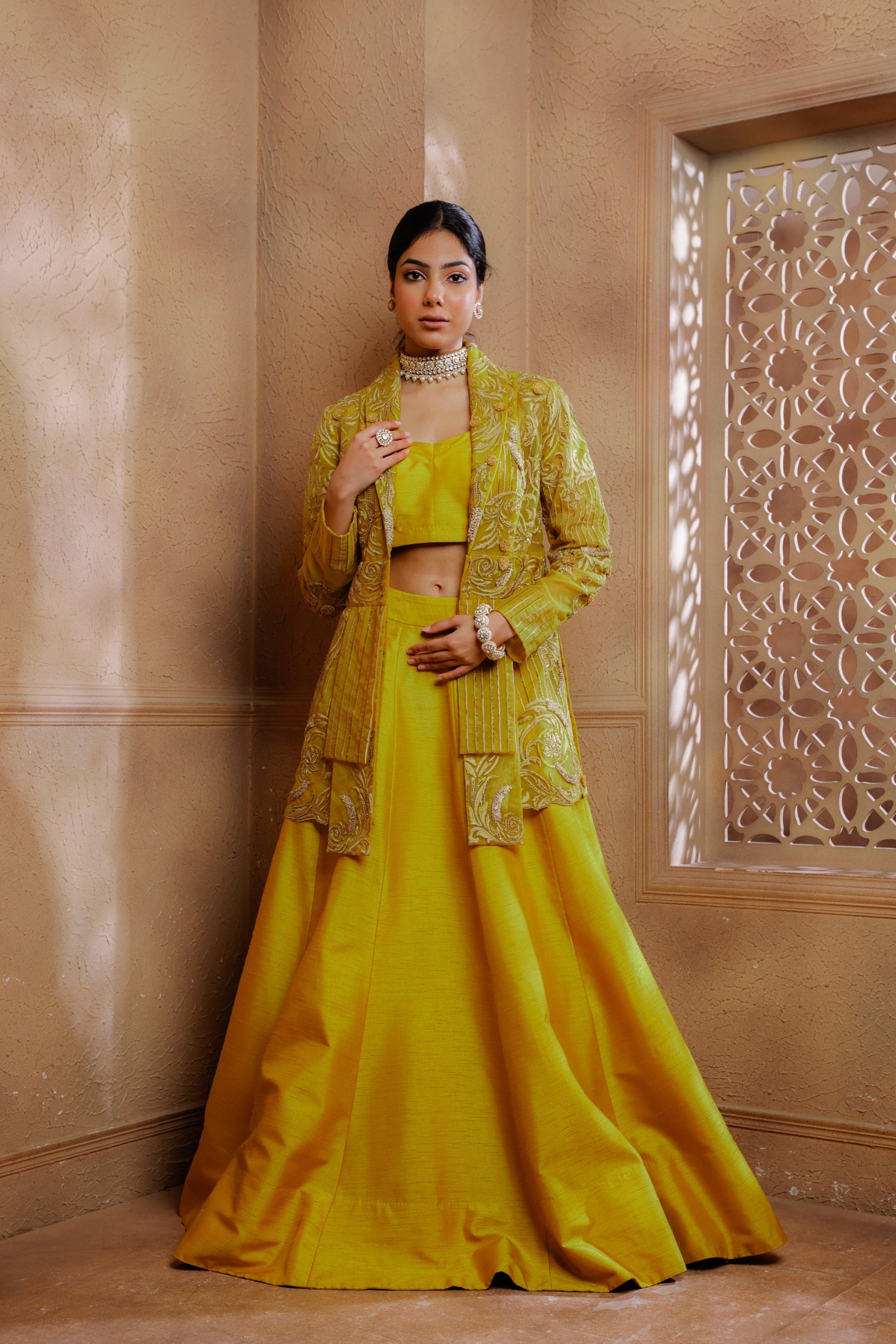 Delicate tonal embroidery adorns the jacket, creating a romantic and feminine allure paired with a blouse & lehenga.