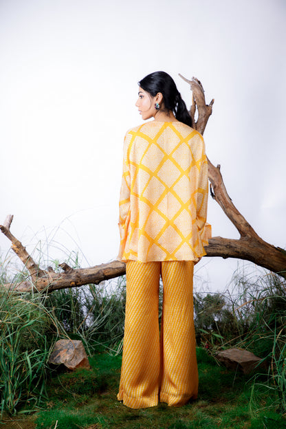 Contrasting Bandhani prints with an oversized asymmetrical cut top paired with a bootleg trouser