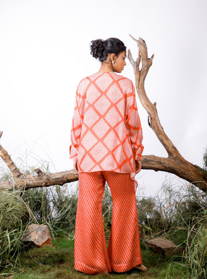 Contrasting Bandhani prints with an oversized asymmetrical cut top paired with a bootleg trouser