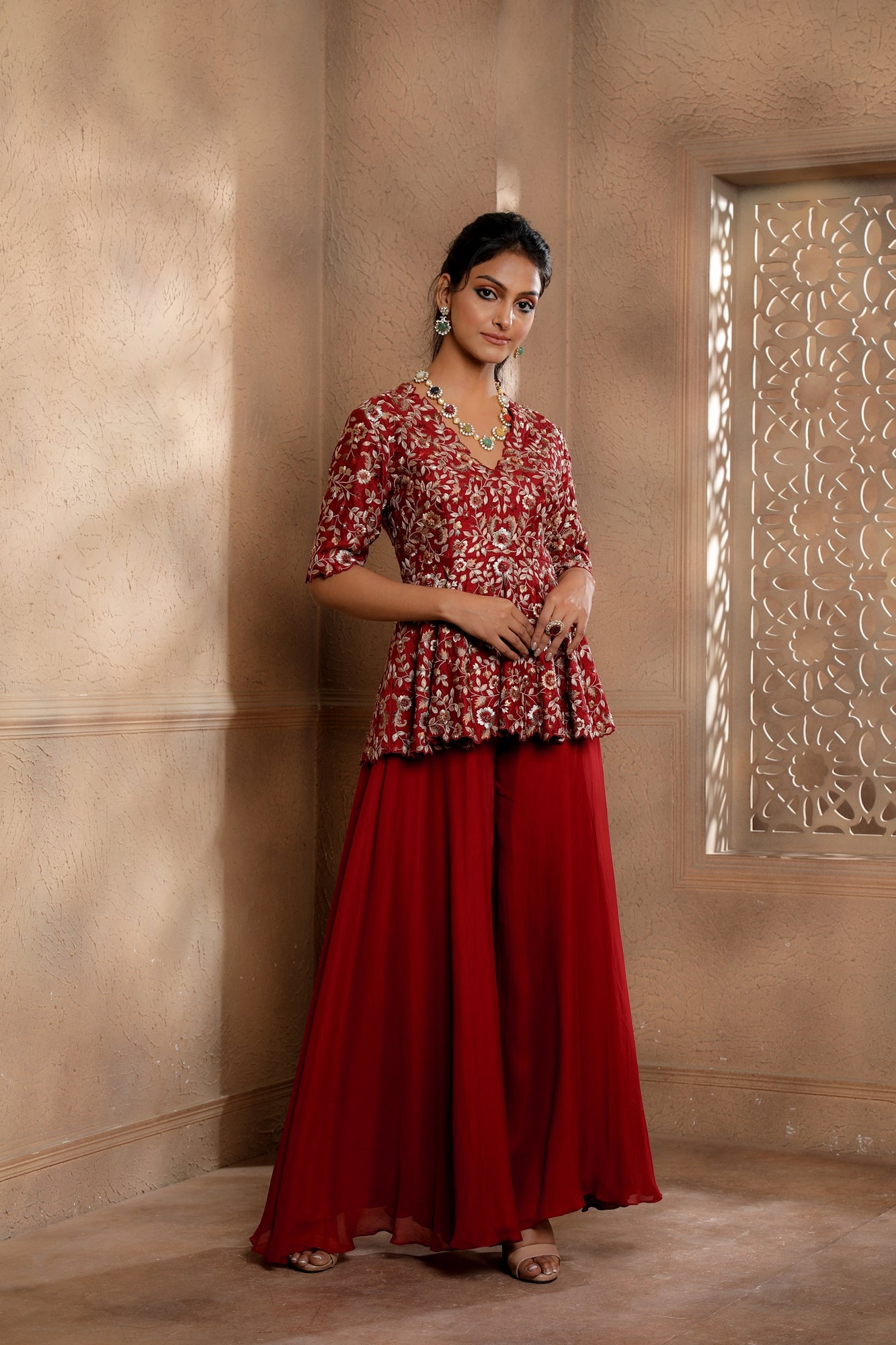 Red Floral Embroidered peplum with contrasting embroidery in hues of gold with an Organza Sharara.