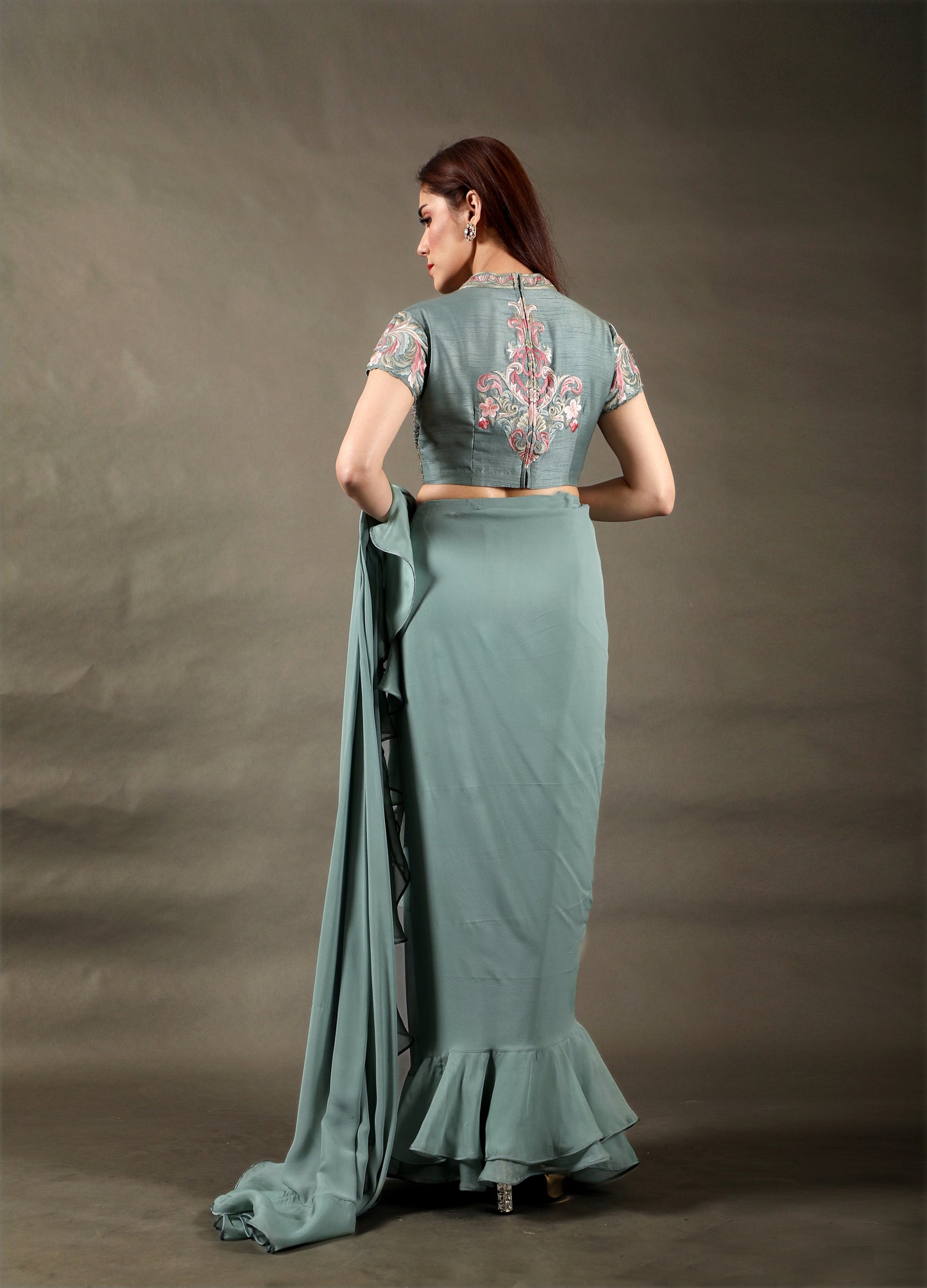 Pre-Draped Saree with Frill on the Pallu and a High neck Multi-color embroidered blouse with hand embroidery.